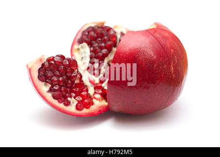 pomegranate being broken into segments  isolated on white background Stock Photo