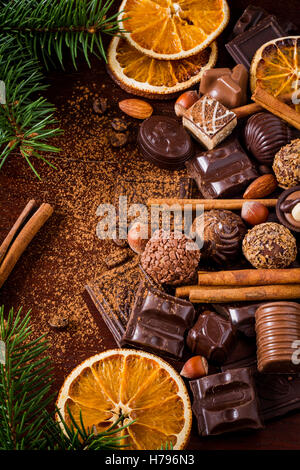 Christmas sweets: assortment of chocolates, truffles, candies, chocolate barks, spices and nuts. Christmas spirit still life Stock Photo