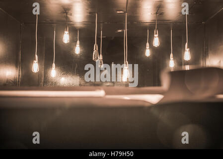 Light globes hanging behind bar Stock Photo