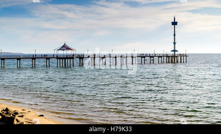 People on Brighton Jetty at sunset on a summer evening Stock Photo
