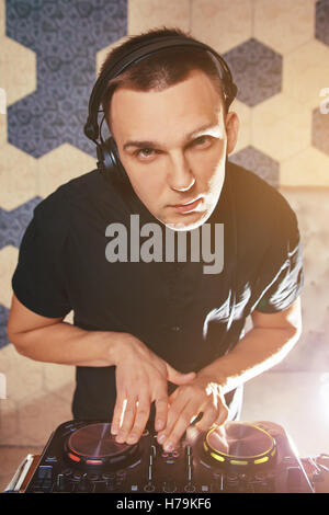 Young man DJ with mixer is working Stock Photo