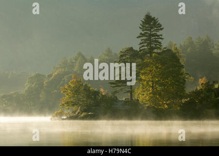 Mist over Lake Derwent Water at dawn, Brandlehow, Borrowdale, The Lake District. Stock Photo