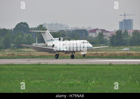 Kiev, Ukraine - July 27, 2011: Yakovlev Yak-40 regional passenger jet plane is landing and touchdownon a cloudy day Stock Photo