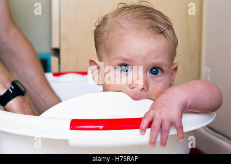 Baby boy teething and having a bath Stock Photo