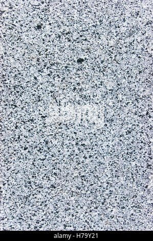 Rough cut granite stone texture, natural vertical gray background, coarse spotted grey plate macro closeup Stock Photo