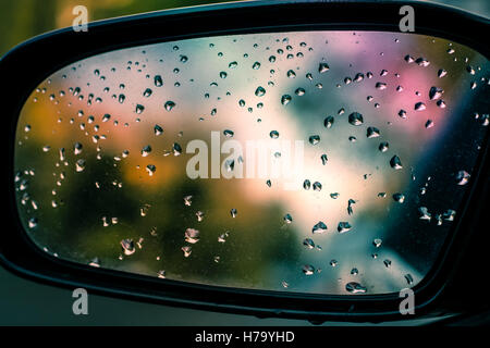 Abstract image of rain drops on car side view mirror Stock Photo