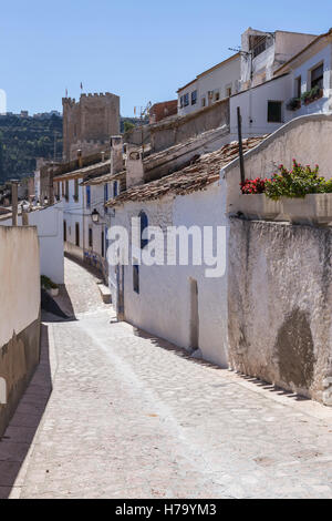 Narrow street with white painted houses, typical of this town, take in Alcala of the Jucar, Albacete province, Spain Stock Photo