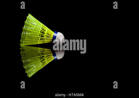 Yellow plastic shuttlecocks with blue strip isolated on black reflective background Stock Photo