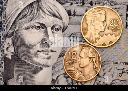Yugoslav coins from 1955 and 1963 showing engineer and farm worker on a 1974 1000 dinar banknote Stock Photo