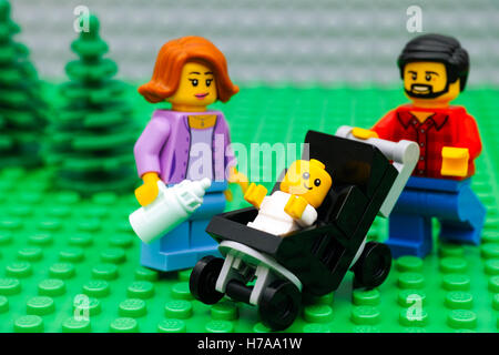 Tambov, Russian Federation - September 21, 2016 Lego family in park. Lego family - father, mother and baby in stroller. Stock Photo