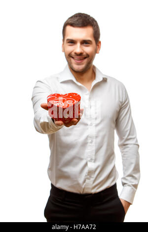 Young man carries heart shaped box Stock Photo