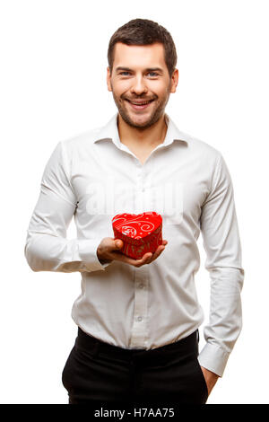 Young man carries heart shaped box Stock Photo