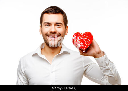 Young man carries heart shaped box Stock Photo