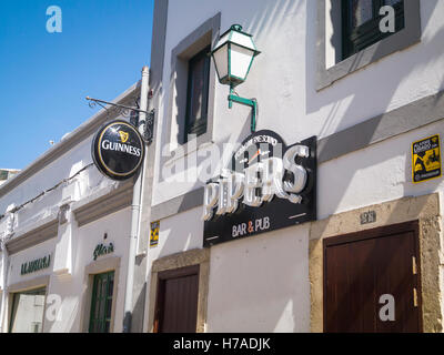 Portugal Algarve 4th c BC ancient old city port Faro Pipers bar & pub Guinness sign street light lamp on wall Stock Photo