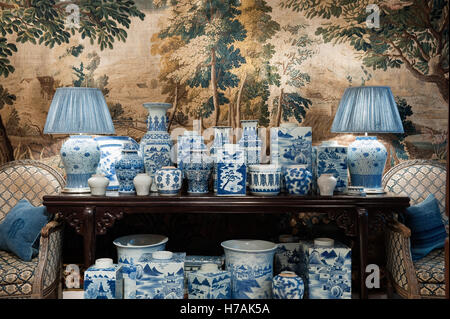 A collection of Chinese blue and white porcelain planters and baluster vases on console table with tapestry back drop Guinevere Stock Photo