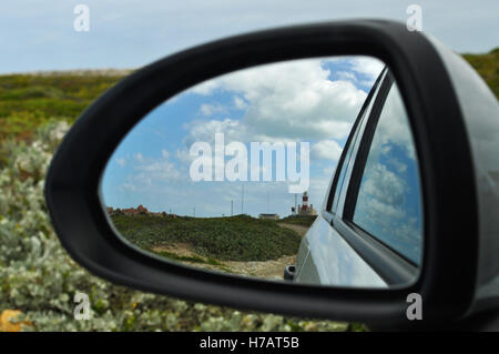 South Africa: the Cape Agulhas Lighthouse, built in 1849 on the southern edge of the village of L'Agulhas, reflected in the rearview mirror of a car Stock Photo