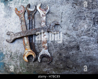 Old rusty wrench on metal background Stock Photo