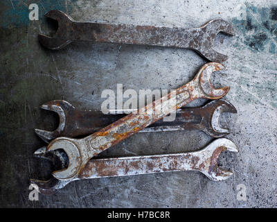Old rusty wrench on metal background Stock Photo