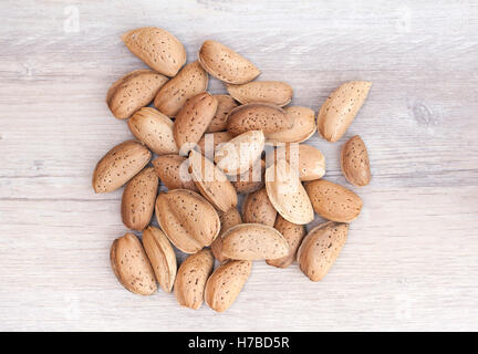 Close up of a bunch of raw almonds in their shells Stock Photo