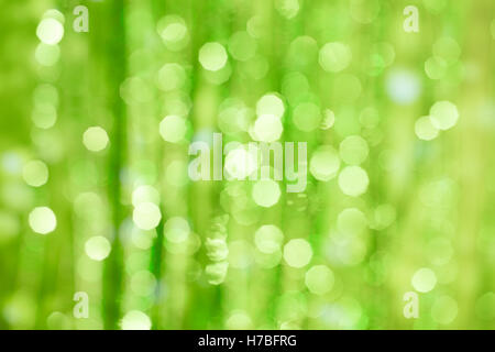 Green defocused background with distant silhouettes Stock Photo