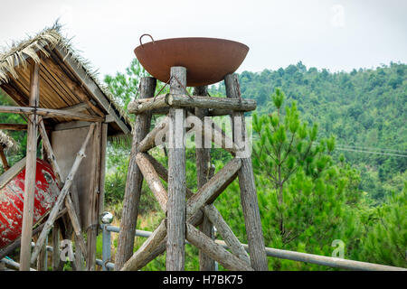 ancient burner.steel pan on a wooden stand.oil or coal used as fuel. Stock Photo