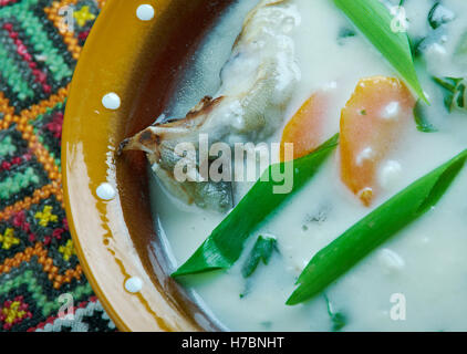 Zupa rybna - vintage Fish soup in Galichyna with sour cream and dumplings Stock Photo
