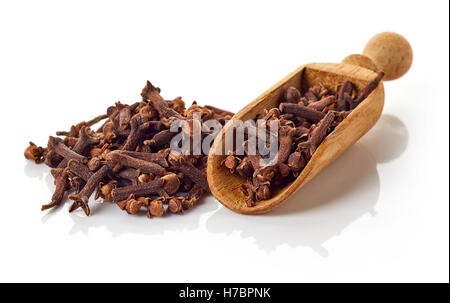 Heap of dry cloves and shovel isolated on white background Stock Photo