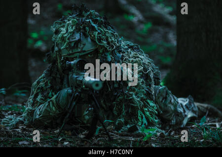 sniper wearing ghillie suit Stock Photo