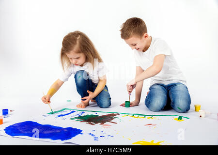 Girl painting with bright gouache paper floor Stock Photo - Alamy