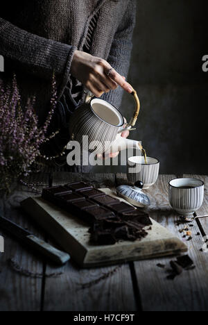 Tea time: woman pouring tea in a cup Stock Photo