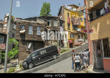 An old wooden house on a steep street in a old residential neighbourhood in Istanbul Stock Photo