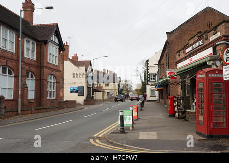 A view of the main street in the village of Hawarden showing the post office and 2 public houses Stock Photo