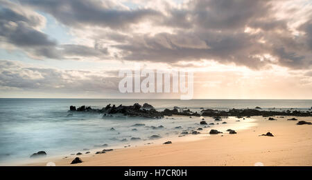 Ascension Island Rocks at Dead Man's Beach Georgetown at sunset artistic long exposure Stock Photo