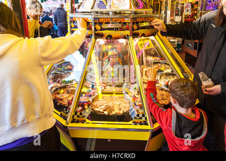 People playing slot machines in an amusements arcade at Goose Fair, Nottingham, England, UK Stock Photo