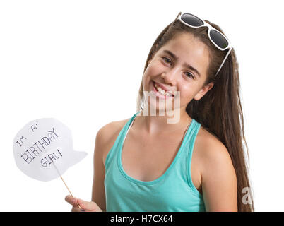 Smiling teenager girl with sunglasses holding an I'm a Birthday Girl sign - isolated on white Stock Photo