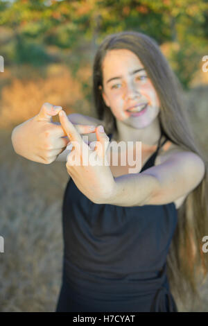 Best Friends Forever - 13 year old teenage girl making the infinity forever sign to signify BFF Stock Photo