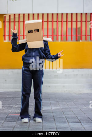 Photograph of a teen with a carton head mask Stock Photo