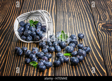 Blueberry on wooden table background. Ripe and juicy fresh picked blueberries closeup. Berries closeup Stock Photo