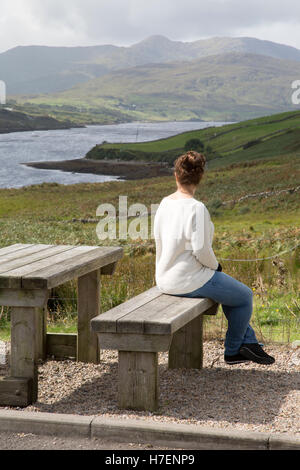 Young Woman looking at Killary Fjord Lake; Leenane, Connemara; Galway; Ireland Stock Photo