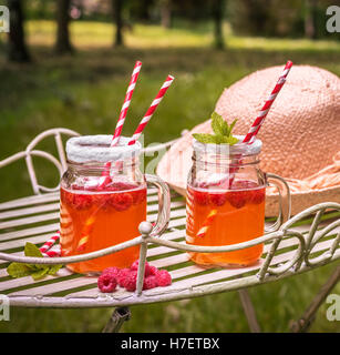 Relaxing in summer with raspberry fruit drinks - square format Stock Photo