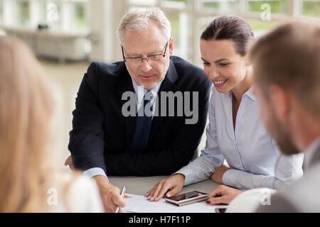 architects with smartphone and blueprint at office Stock Photo