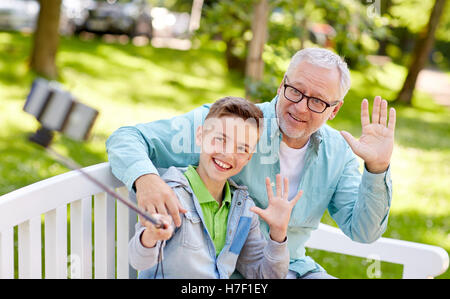 old man and boy taking selfie by smartphone Stock Photo
