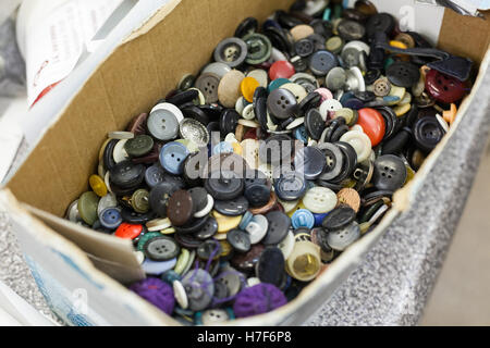 it is a lot of buttons in a box. a workshop on tailoring of theatrical suits. Stock Photo
