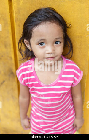 MANILA,PHILIPPINES-OCTOBER 24,2016: Little girl plays in the streets of manila on October 24, Manila,Philippines. Stock Photo