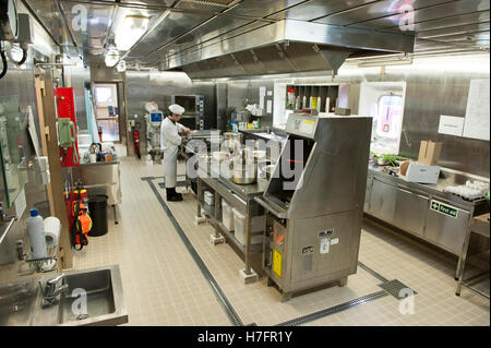 Chef cooking in galley on board a merchant ship Stock Photo