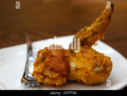 Singapore style crispy, golden brown chicken wing deep fried to perfection, with copy space. Stock Photo