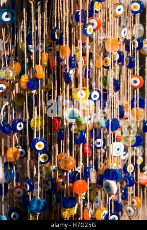 Various colors of amulets hanging on ropes. Stock Photo