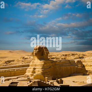 Full length head to toe body and profile of the Great Sphinx at the Egyptian Great Pyramids on a blue sky day in Cairo, Egypt Stock Photo