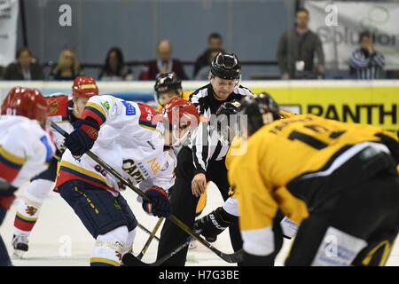 Ice Hockey official/referee dropping the puck during an opening face off Stock Photo