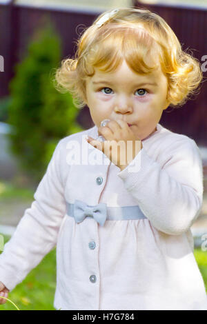 Portrait of cute baby girl with curly blond hair Stock Photo